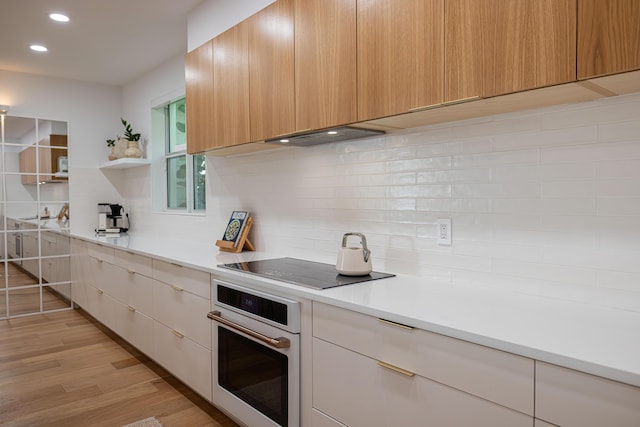 3245 Wymberly Dr, Jupiter, FL 33458 - kitchen featuring white oven, modern cabinets, tasteful backsplash, open shelves, and light countertops