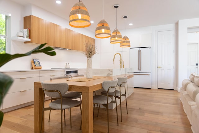 3245 Wymberly Dr, Jupiter, FL 33458 - kitchen with high end white fridge, modern cabinets, light countertops, recessed lighting, and light wood finished floors