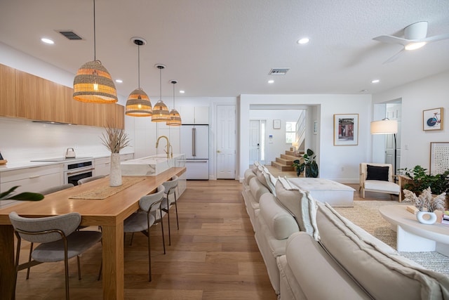 3245 Wymberly Dr, Jupiter, FL 33458 - living area with stairway, light wood-type flooring, recessed lighting, and a ceiling fan
