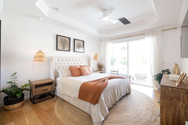 3245 Wymberly Dr, Jupiter, FL 33458 - bedroom featuring a raised ceiling, access to exterior, crown molding, light wood-style flooring, and a ceiling fan