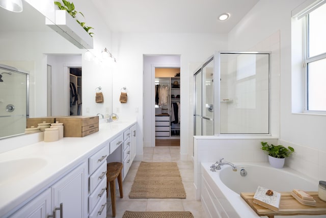 3245 Wymberly Dr, Jupiter, FL 33458 - bathroom featuring double vanity, a spacious closet, a shower stall, a bath, and tile patterned flooring