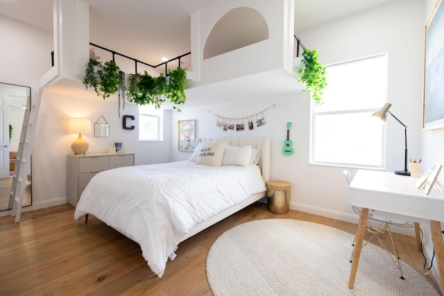 3245 Wymberly Dr, Jupiter, FL 33458 - bedroom with baseboards and light wood finished floors