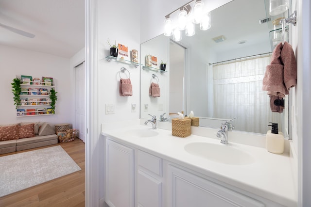 3245 Wymberly Dr, Jupiter, FL 33458 - bathroom featuring double vanity and wood finished floors