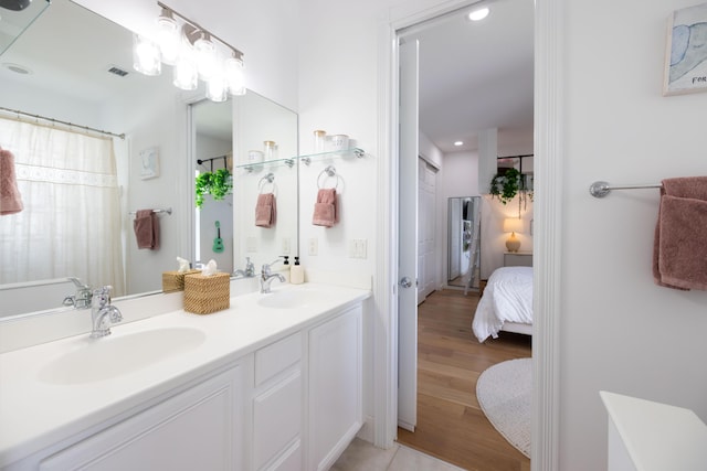 3245 Wymberly Dr, Jupiter, FL 33458 - ensuite bathroom with double vanity, recessed lighting, and wood finished floors