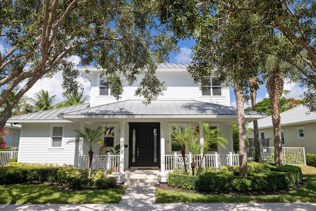 3245 Wymberly Dr, Jupiter, FL 33458 - view of front of property with a standing seam roof, covered porch, and a metal roof