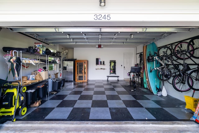 3245 Wymberly Dr, Jupiter, FL 33458 - garage with stainless steel fridge and a garage door opener