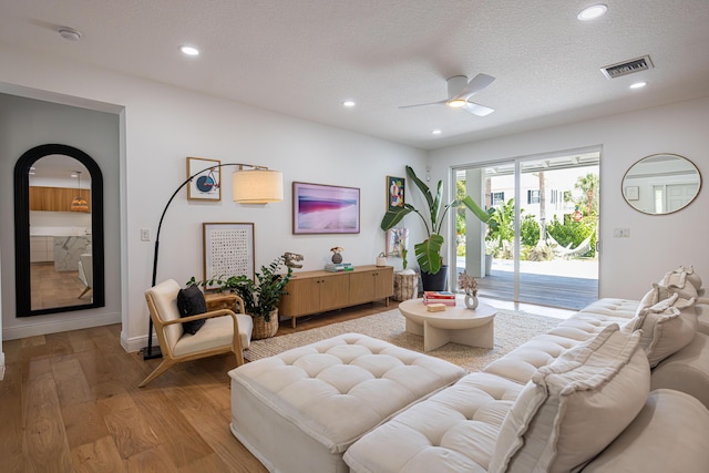 3245 Wymberly Dr, Jupiter, FL 33458 - living area featuring light wood-type flooring, a ceiling fan, recessed lighting, and a textured ceiling