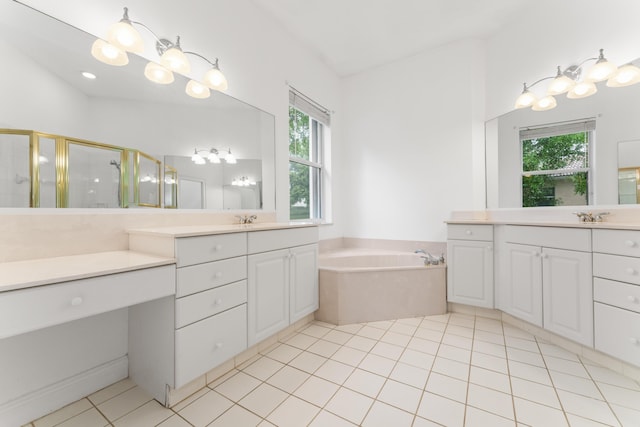 918 SW Blue Stem Way, Stuart, FL 34997 - bathroom featuring a stall shower, two vanities, a garden tub, and tile patterned floors
