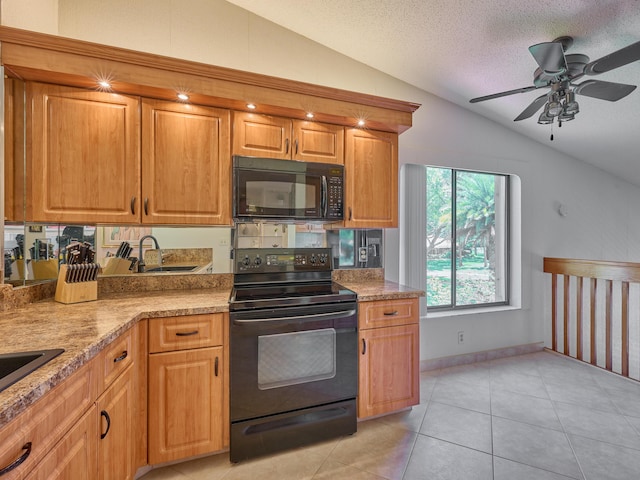 10828 Lake Palm Ln Unit 202, Boynton Beach, FL 33437 - kitchen with black appliances, vaulted ceiling, a ceiling fan, light tile patterned flooring, and a textured ceiling