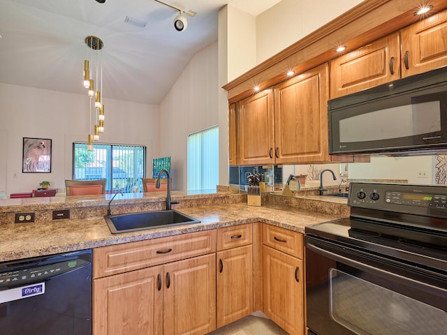 10828 Lake Palm Ln Unit 202, Boynton Beach, FL 33437 - kitchen with black appliances, hanging light fixtures, track lighting, high vaulted ceiling, and light stone counters