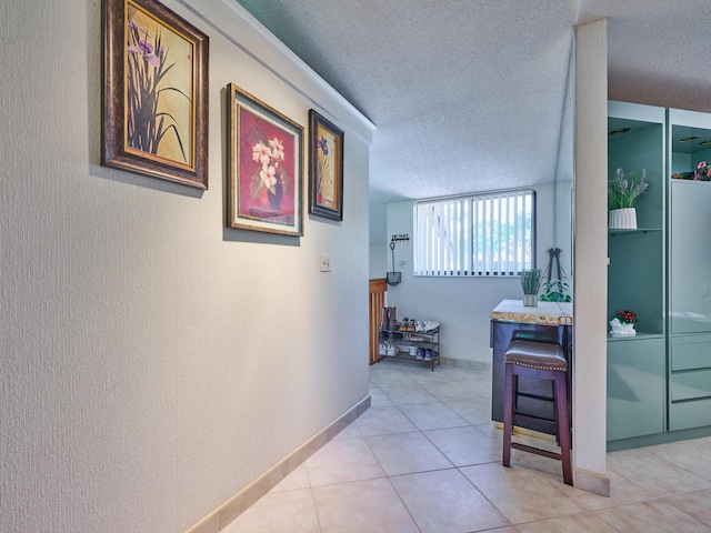 10828 Lake Palm Ln Unit 202, Boynton Beach, FL 33437 - corridor with a textured wall, a textured ceiling, and light tile patterned floors