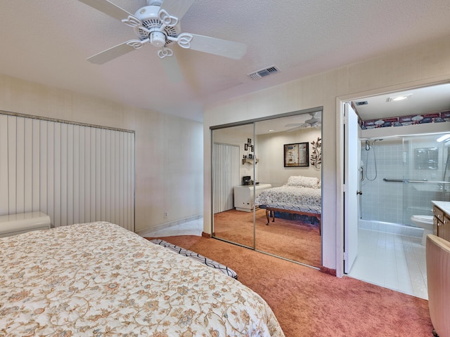 10828 Lake Palm Ln Unit 202, Boynton Beach, FL 33437 - carpeted bedroom featuring a closet, connected bathroom, a ceiling fan, and a textured ceiling