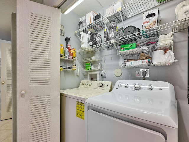 10828 Lake Palm Ln Unit 202, Boynton Beach, FL 33437 - laundry area featuring independent washer and dryer and tile patterned flooring