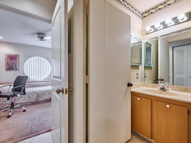 10828 Lake Palm Ln Unit 202, Boynton Beach, FL 33437 - bathroom featuring tile patterned flooring, vanity, ensuite bathroom, ceiling fan, and a textured ceiling