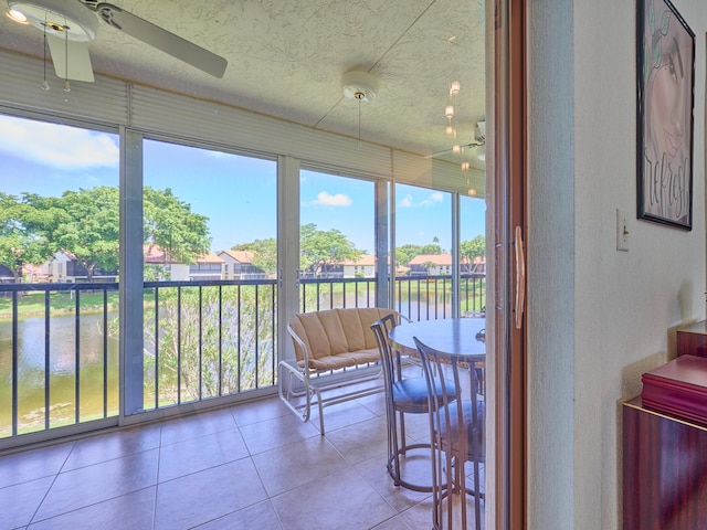 10828 Lake Palm Ln Unit 202, Boynton Beach, FL 33437 - sunroom / solarium with a ceiling fan, a water view, tile patterned floors, and a textured ceiling