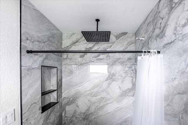 673 NE Horizon Ln, Port Saint Lucie, FL 34983 - bathroom featuring a marble finish shower and a textured ceiling