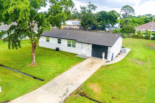 673 NE Horizon Ln, Port Saint Lucie, FL 34983 - view of front of house with driveway, a shingled roof, and a front yard