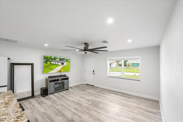 673 NE Horizon Ln, Port Saint Lucie, FL 34983 - unfurnished living room with light wood-type flooring, recessed lighting, and a ceiling fan