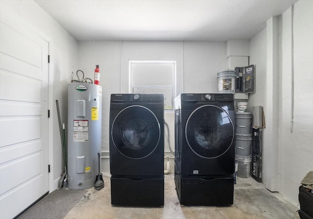 673 NE Horizon Ln, Port Saint Lucie, FL 34983 - laundry area featuring electric water heater and washer and dryer