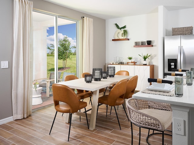 14328 SW Rain Rd, Indiantown, FL 34956 - dining area featuring wood finished floors and plenty of natural light
