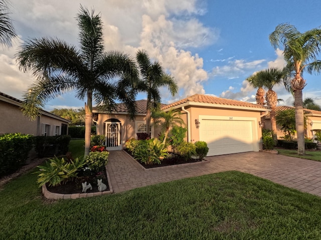 397 NW Breezy Point Loop, Port Saint Lucie, FL 34986 - mediterranean / spanish-style home with a garage, driveway, a tile roof, and a front lawn