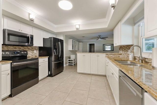 1546 35th Ave, Vero Beach, FL 32960 - kitchen featuring appliances with stainless steel finishes, a peninsula, tasteful backsplash, ornamental molding, and white cabinetry