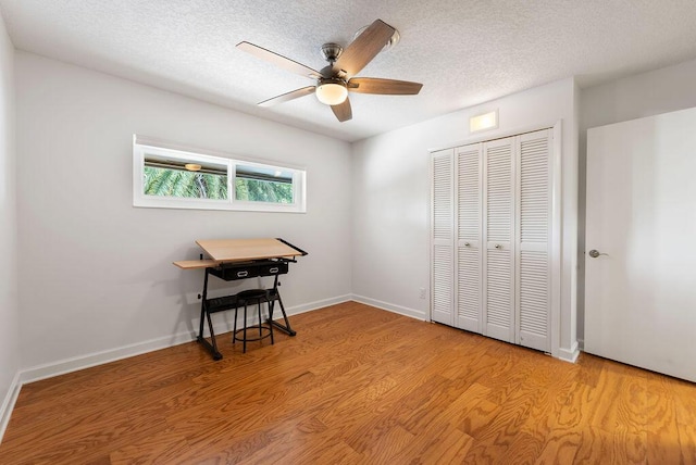 1546 35th Ave, Vero Beach, FL 32960 - bedroom with a closet, a textured ceiling, light wood-style flooring, and a ceiling fan