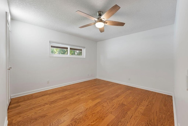 1546 35th Ave, Vero Beach, FL 32960 - spare room featuring a textured ceiling, light wood-type flooring, and a ceiling fan