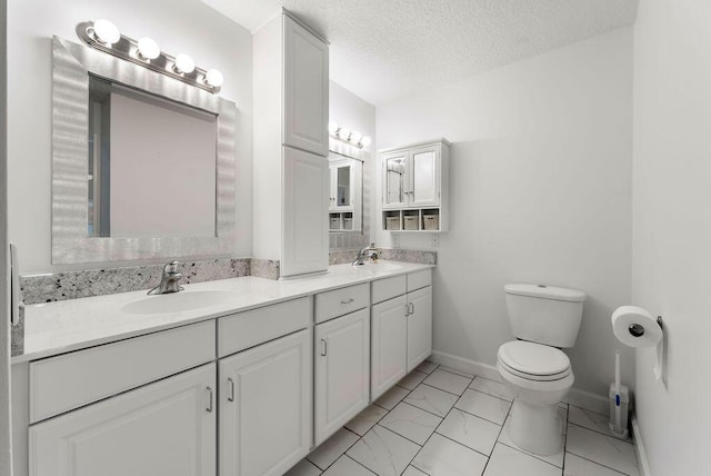 1546 35th Ave, Vero Beach, FL 32960 - bathroom with double vanity, marble finish flooring, and a textured ceiling