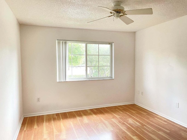 7832 Sonoma Springs Cir Unit 203, Lake Worth, FL 33463 - unfurnished room featuring light wood-style flooring, ceiling fan, and a textured ceiling