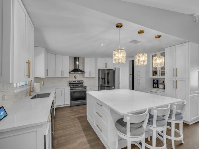 17516 Birchwood Dr, Boca Raton, FL 33487 - kitchen featuring stainless steel appliances, wall chimney range hood, a chandelier, and backsplash