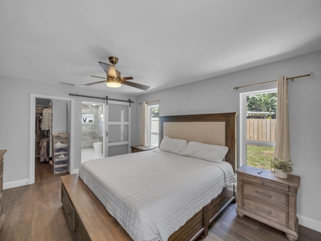 17516 Birchwood Dr, Boca Raton, FL 33487 - bedroom featuring a walk in closet, multiple windows, dark wood-style flooring, and a closet