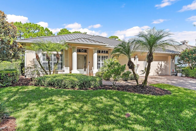 5885 SE Forest Glade Trl, Hobe Sound, FL 33455 - single story home featuring a standing seam roof, stucco siding, a garage, and a front yard