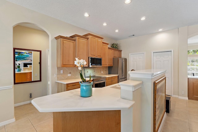 5885 SE Forest Glade Trl, Hobe Sound, FL 33455 - kitchen featuring stainless steel appliances, light tile patterned floors, light countertops, tasteful backsplash, and recessed lighting