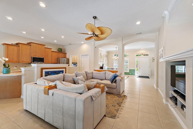 5885 SE Forest Glade Trl, Hobe Sound, FL 33455 - living room with arched walkways, light tile patterned flooring, recessed lighting, and a ceiling fan
