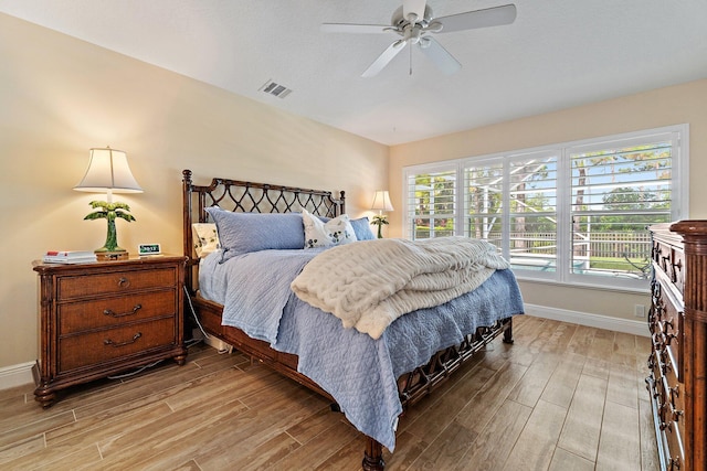 5885 SE Forest Glade Trl, Hobe Sound, FL 33455 - bedroom featuring light wood finished floors and ceiling fan