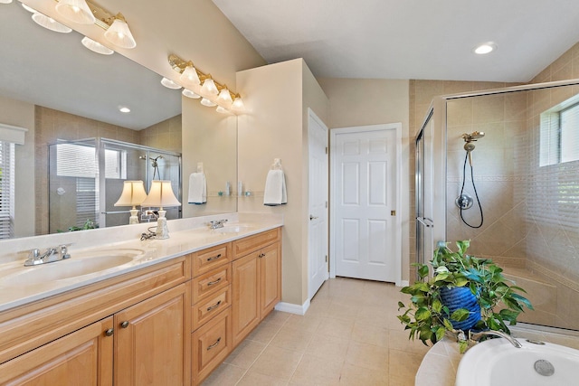 5885 SE Forest Glade Trl, Hobe Sound, FL 33455 - full bathroom featuring double vanity, a shower stall, tile patterned floors, and a tub