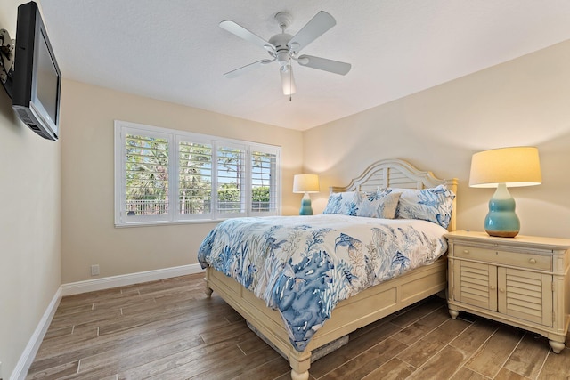 5885 SE Forest Glade Trl, Hobe Sound, FL 33455 - bedroom with wood finished floors and a ceiling fan