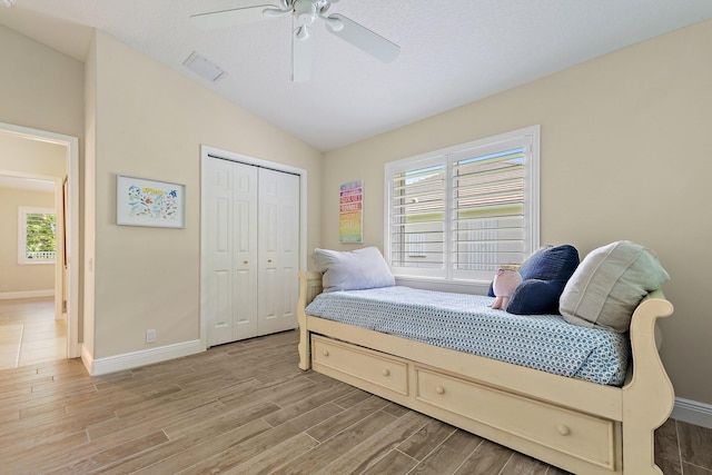 5885 SE Forest Glade Trl, Hobe Sound, FL 33455 - bedroom with light wood-type flooring, a closet, lofted ceiling, and ceiling fan