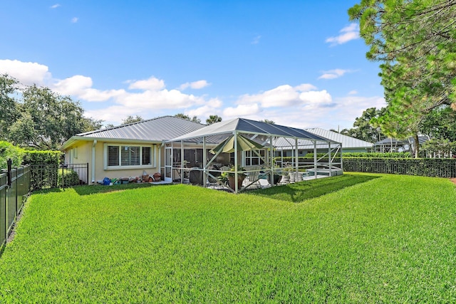 5885 SE Forest Glade Trl, Hobe Sound, FL 33455 - rear view of property featuring a fenced backyard, stucco siding, a metal roof, and glass enclosure