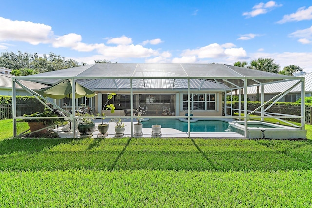 5885 SE Forest Glade Trl, Hobe Sound, FL 33455 - back of property with a patio, glass enclosure, and a pool with connected hot tub