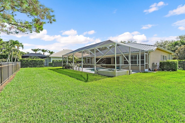5885 SE Forest Glade Trl, Hobe Sound, FL 33455 - rear view of property featuring a fenced backyard, an outdoor pool, stucco siding, a patio area, and a lanai