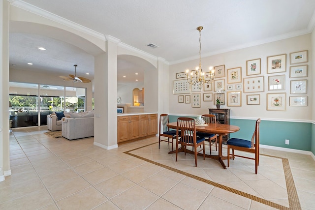 5885 SE Forest Glade Trl, Hobe Sound, FL 33455 - dining space with arched walkways, crown molding, ceiling fan, a chandelier, and light tile patterned floors