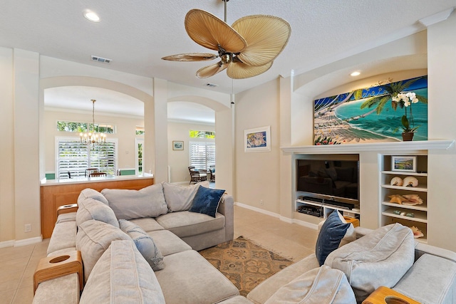 5885 SE Forest Glade Trl, Hobe Sound, FL 33455 - living area featuring arched walkways, tile patterned flooring, recessed lighting, a chandelier, and ceiling fan