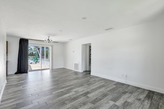 1669 SE N Blackwell Dr, Port Saint Lucie, FL 34952 - spare room with a chandelier and wood finished floors