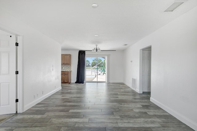 1669 SE N Blackwell Dr, Port Saint Lucie, FL 34952 - unfurnished room with wood finished floors and a chandelier