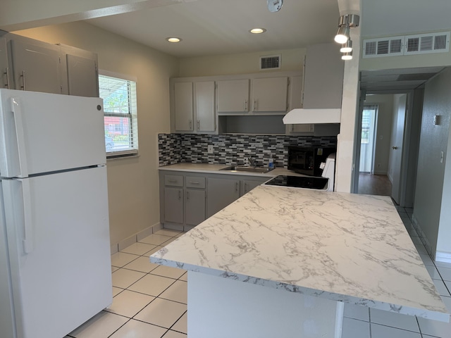 64 Waterford C, Delray Beach, FL 33446 - kitchen with freestanding refrigerator, gray cabinets, tasteful backsplash, light countertops, and recessed lighting