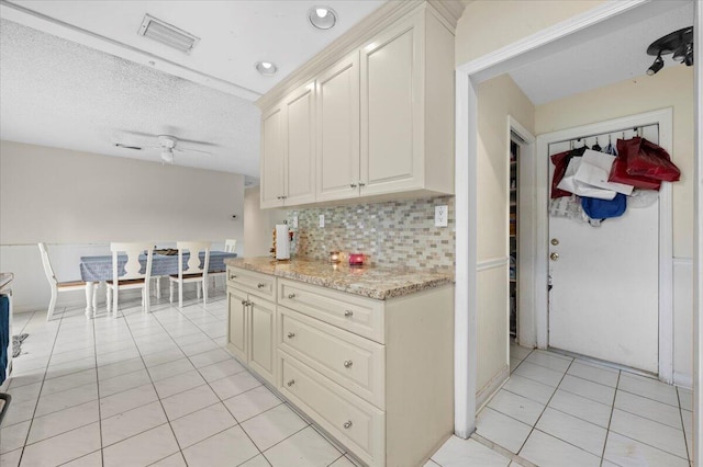 19309 Carolina Cir, Boca Raton, FL 33434 - kitchen with light tile patterned floors, tasteful backsplash, ceiling fan, light stone counters, and a textured ceiling