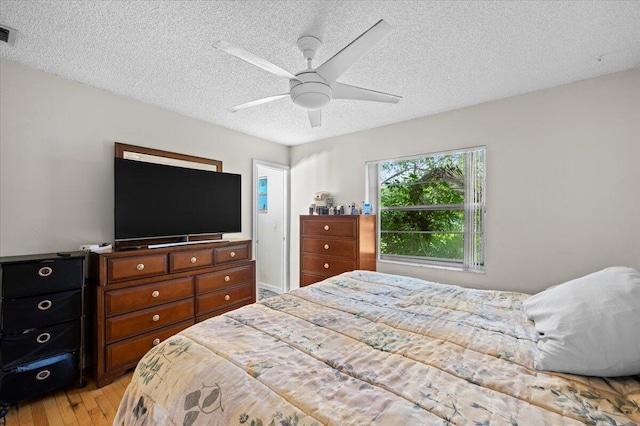 19309 Carolina Cir, Boca Raton, FL 33434 - bedroom featuring a textured ceiling, light wood finished floors, and a ceiling fan