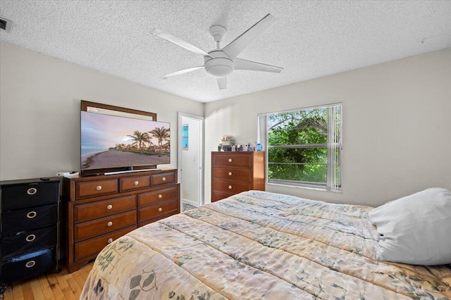 19309 Carolina Cir, Boca Raton, FL 33434 - bedroom featuring a textured ceiling, light wood-style floors, and a ceiling fan